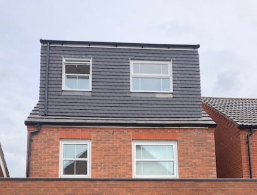 Completed loft conversion on a brick home